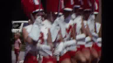 Detriot Michigan (1967): Seven Majorettes Dressed In White And Red Uniforms March