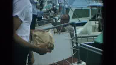 Florida (1967): Fishermen Hand Fish From A Storage Box On A Boat To Men On A Dock
