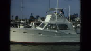 Florida (1967): Three People On White Boat Cruise Through Calm Harbor Under Clear
