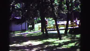 Galena Illinois USA (1967): Men Walking While Carrying Boxes In Between Building