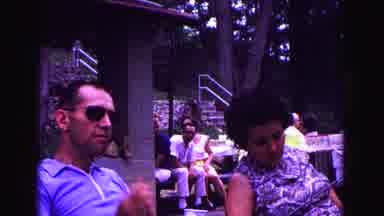 Galena Illinois USA (1967): Woman And Man Sit On Sun Loungers And The Man Beckons