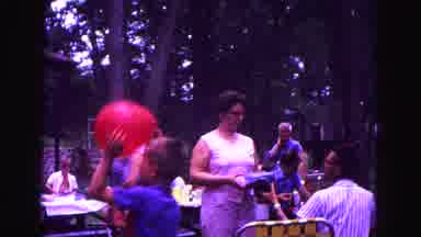 Galena Illinois USA (1967): People Sit At A Table At A Local Park While Child