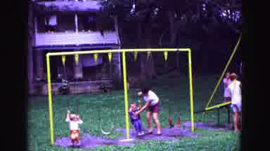 Galena Illinois USA (1967): Parents And Children Playing Outside On A Swing Set