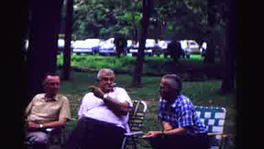 Galena Illinois USA (1967): Three Old Men Sat On Lawn Chairs Talking With A Little