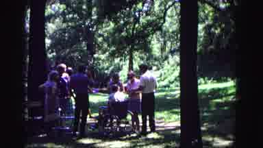 Galena Illinois USA (1967): People Stand Around Aman In A Wheelchair Conversing In
