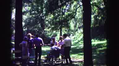 Galena Illinois USA (1967): People Congregate Around A Man In A Wheelchair In A N