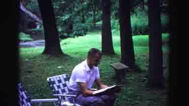 Galena Illinois USA (1967): Man Reads Newspaper In Yard Outside While 3 Ladies