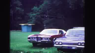 Galena Illinois USA (1967): Two Fancy Red American Muscle Cars Are Parked In A