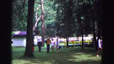 Galena Illinois USA (1967): Couple Walking Arm In Arm With A Third Person Under