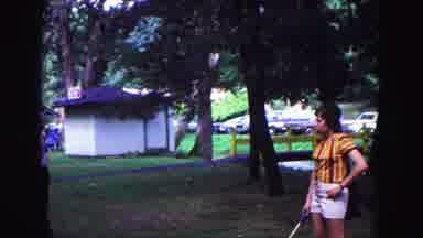 Galena Illinois USA (1967): People Are Playing A Game Outdoors And The Man Jogs Up