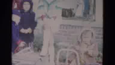 Lincoln Nebraska (1967): Close Family Watches Small Child Jump On Toy Car