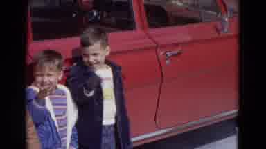 Lincoln Nebraska (1967): Three Small Children Wearing Jackets Waving At The Camera
