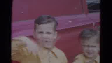 Lincoln Nebraska (1967): Two Young Boys In Matching Yellow Shirts Wave To The