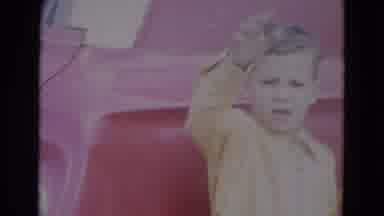 Lincoln Nebraska (1967): Two Children Waving In Yellow Suits In Front Of A Red Car