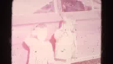 Lincoln Nebraska (1967): Two Young Male Toddlers Stand Outside Of A Car And Wave