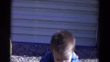 Lincoln Nebraska (1967): Toddler Swinging Arms Playing With Mother Near House On