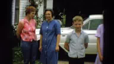 Minnesota US (1967): Four People Smiling In Front Of A Parked White Car