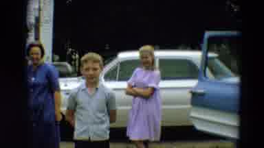 Minnesota USA (1967): Family Including Two Children Standing Beside Cars While
