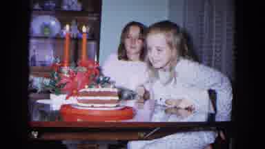 New Mexico USA (1967): Girl Tries To Flow Off Candle On Her Cake While Another