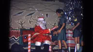 New Mexico USA (1967): Explorer Girls Walking Next To Santa Receiving Gifts For
