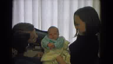 New Mexico USA (1967): Two Young Women Cooing Over A Very Young Baby Wearing Blue