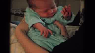 New Mexico USA (1967): Small Child Wakes Up And Moves His Hands In His Mother's