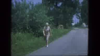 New Mexico USA (1967): A Woman Casually Walks Up A Road In The Day Time