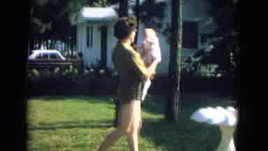 New Mexico USA (1967): Women Carrying Baby In Front Of A House And Walking Inside