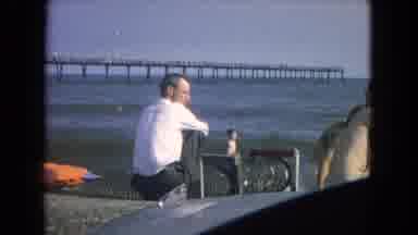 New Mexico USA (1967): Child Points Out To Sea With Other Children On A Beach With
