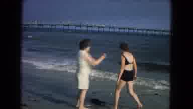New Mexico USA (1967): Two Ladies At The Beach With A Pier In The Background