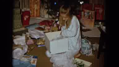New Mexico USA (1967): Little Girl Opens Christmas Present Surrounded By Torn
