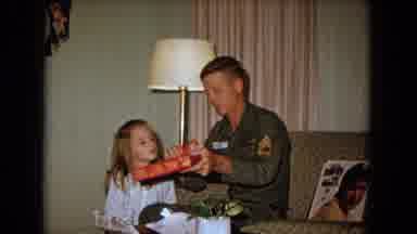 New Mexico USA (1967): Man Presents His Daughter With Great Joy In The Living Room