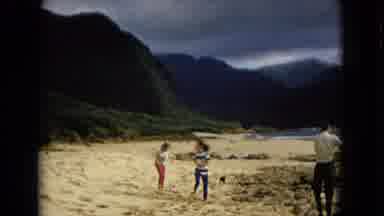 New Mexico USA (1967): Family Walking On A Sandy Beach With A Little Black Pet Dog