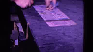 Trenton New Jersey (1967): Man Sticks Blue Stickers Onto A Printed Sheet Of Paper