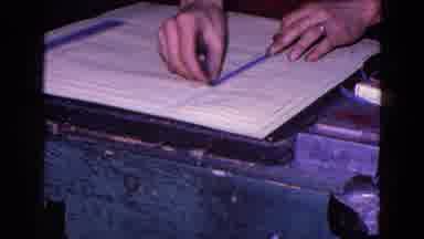 Trenton New Jersey (1967): A Person Wearing A Ring Putting A Strip Of Paper On A