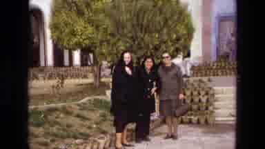 Iran (1972): Three People Stand And Pose In Front Of The Building Before Looking
