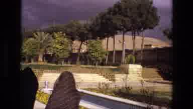 Iran (1972): Camera Captures The Building And People Walking By As Dark Clouds