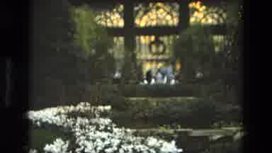 Iran (1972): People Seen Walking Through An Indoor Garden With Flowers Trees