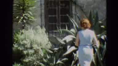 Branson Missouri USA (1968): A Woman In White Dress And A Bag In Hand Is Walking