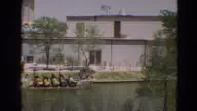 Branson Missouri USA (1968): Long Open Passenger Boat Sails Down River Inside City