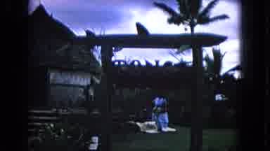 Honolulu Hawaii (1968): Woman Wearing White Dress Walks Off Yellow Mat On A Cloudy