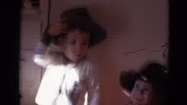Lincoln Nebraska (1968): Two Young Boys In Cowboy Hats Play Indoors Together