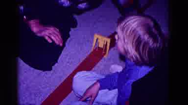 Minnesota USA (1968): Boy Enjoying Playing With Car Track With Man