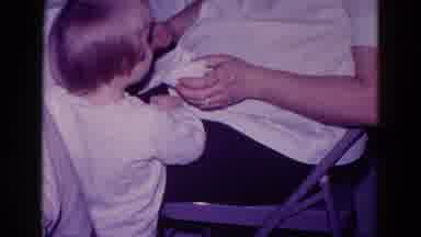 Minnesota USA (1968): A Small Child Aged 2 To 3 Years And Her Grandmother Wiping