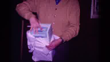 Minnesota USA (1968): Middle Aged Man Happily Opening A Large Present At Home