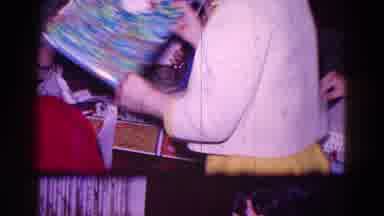 Minnesota USA (1968): Family Excitedly Unwrapping Christmas Gifts Together In A
