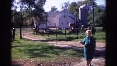 Wauconda Illinois USA (1968): A Lady Walking In Her Yard Waving To A Camera