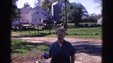 Wauconda Illinois USA (1968): Lady Holding Something In Her Hand Walking Backwards