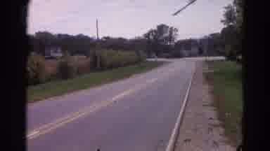 Wauconda Illinois USA (1968): A Road With Plants On Either Side And A Vehicle