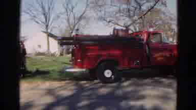 Wauconda Illinois USA (1968): Red Fire Truck In Reverse On A Road And A Field With